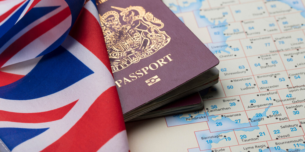 A passport with the UK's national flag - UK Implements Increased Visa Charges