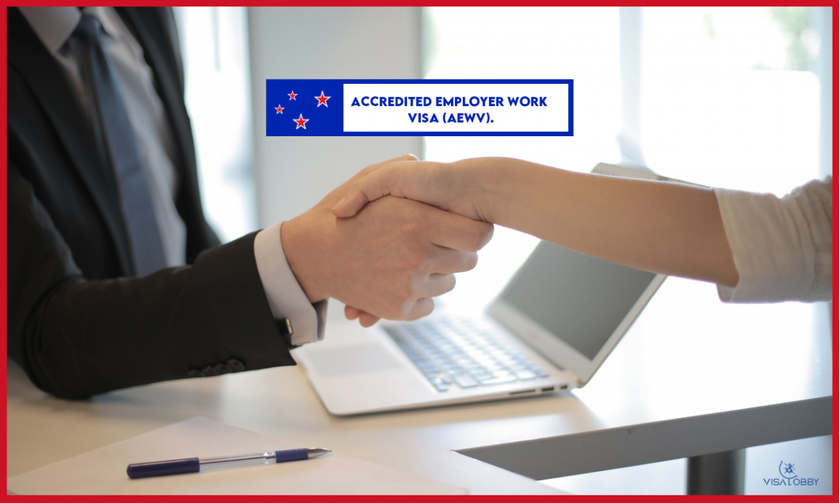 Two persons are handshaking and a laptop is on desk - Accredited Employer Work Visa