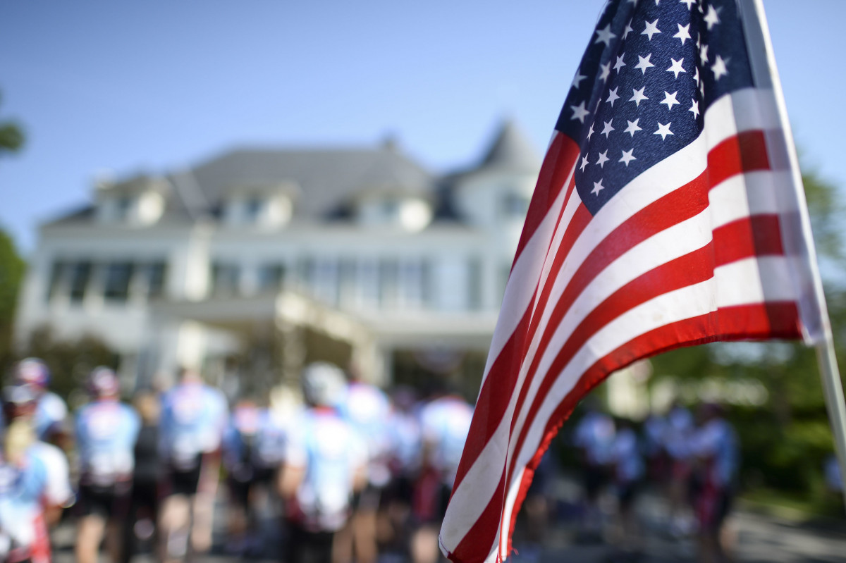 A US flag with people in the background - Merit-Based Immigration