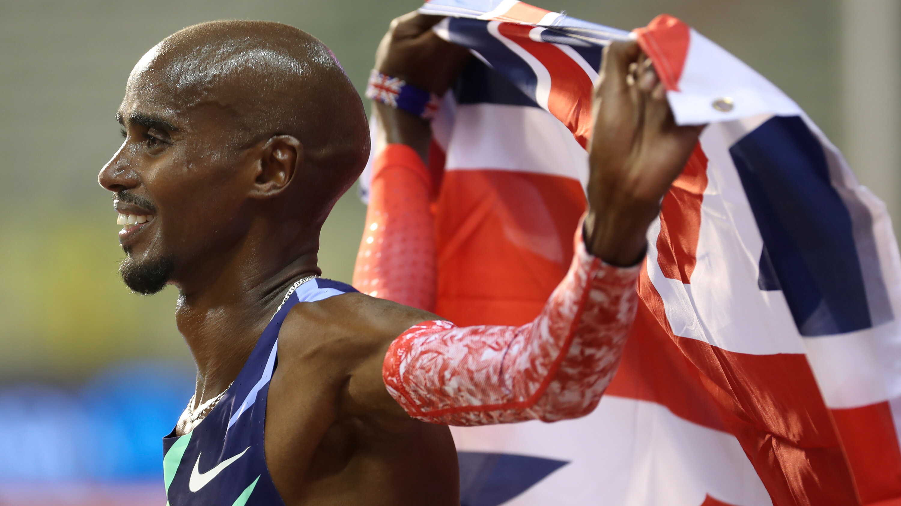 Mo Farah holding the UK's flag - Emminent Immigrants in the UK