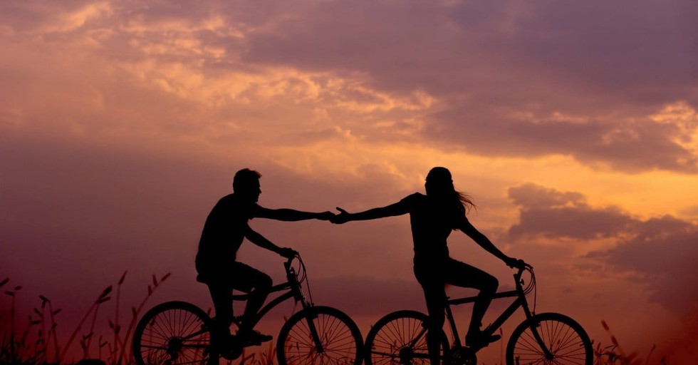 A couple cycling in the evening - A Short Guide to UK Spouse Visa Interviews