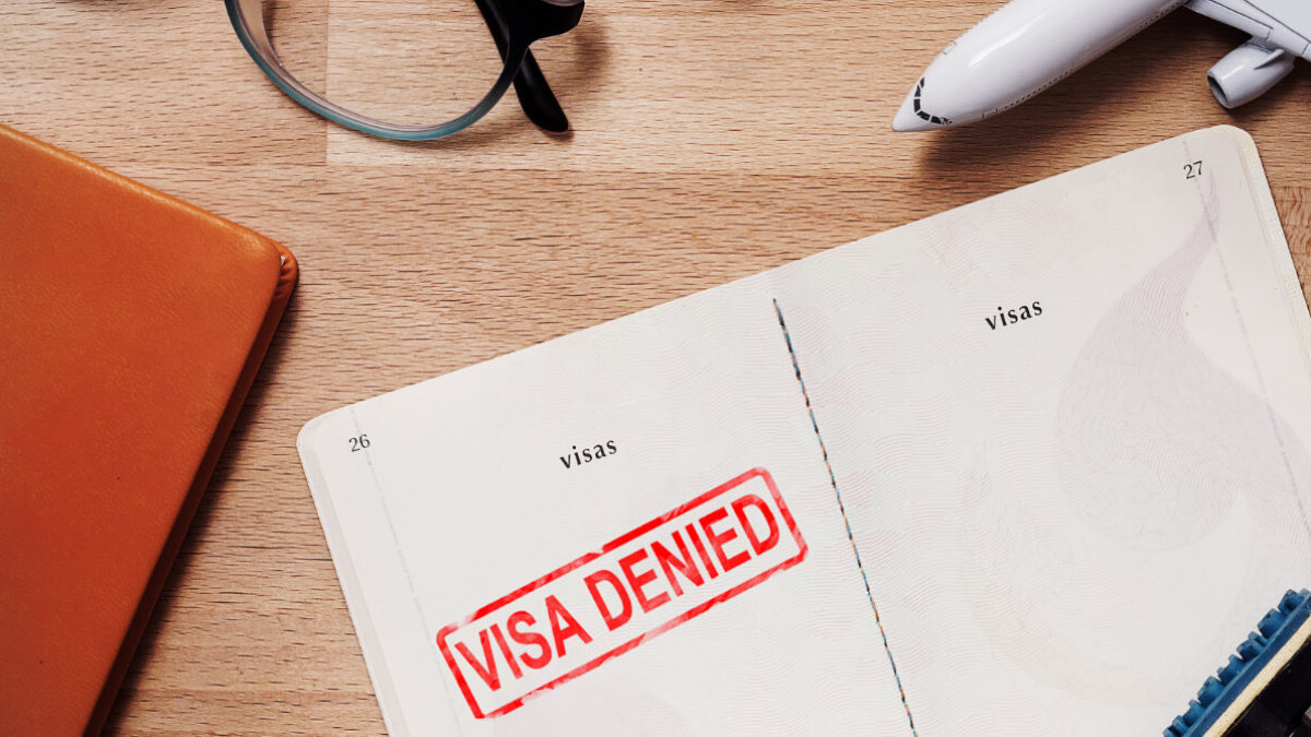 A blank page with "Visa Denied" stamp on it - Commonwealth Report Shows No Improvement in UK Visas